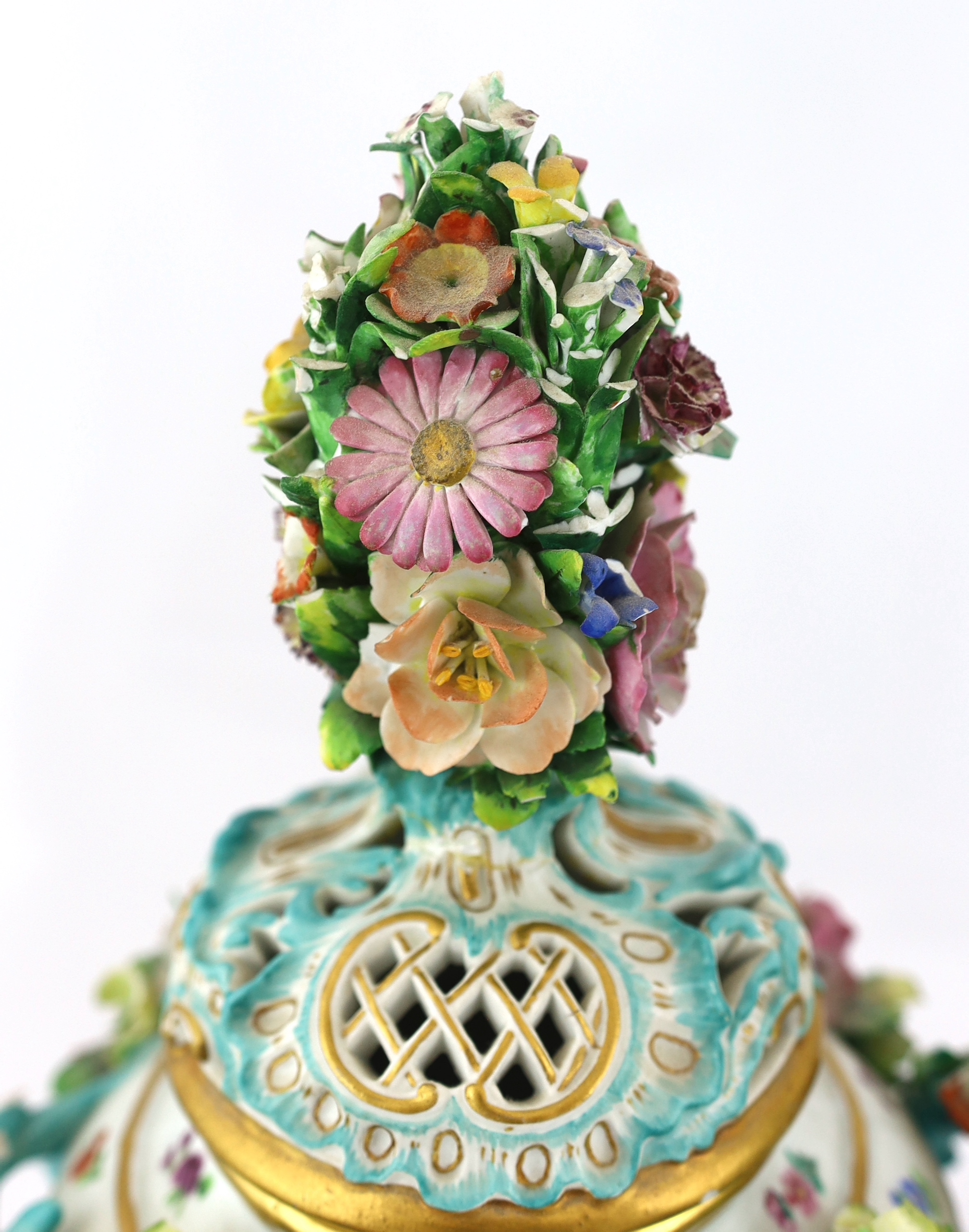A pair of Meissen topographical flower encrusted vases and covers, 19th century, losses